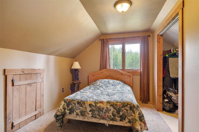 Carpeted bedroom featuring vaulted ceiling | Image 52