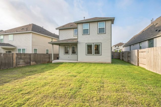 Rear view of house with a patio and a shingled roof | Image 4