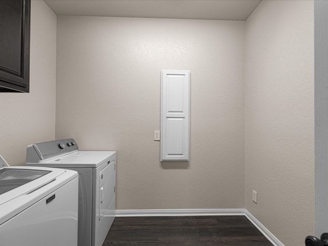 Laundry room featuring full size washer and dryer. Extra room for a fridge or freezer. | Image 12