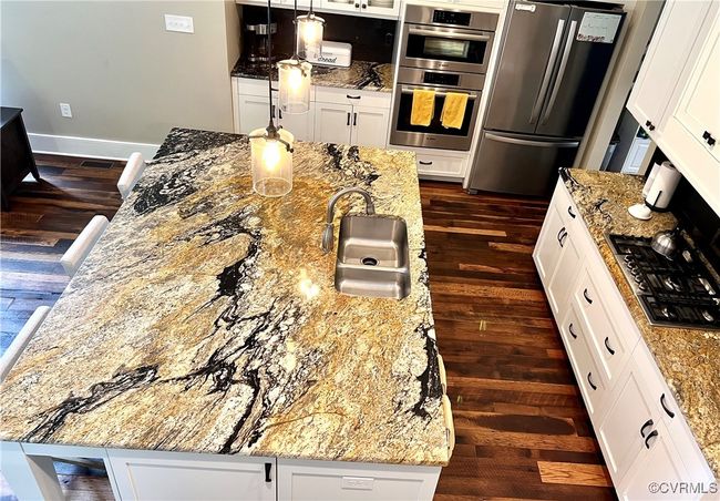 Kitchen with appliances with stainless steel finishes, dark wood-type flooring, and white cabinets | Image 4