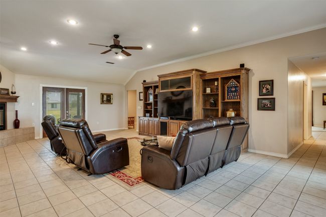Living area with ornamental molding, recessed lighting, a ceiling fan, and light tile patterned floors | Image 4