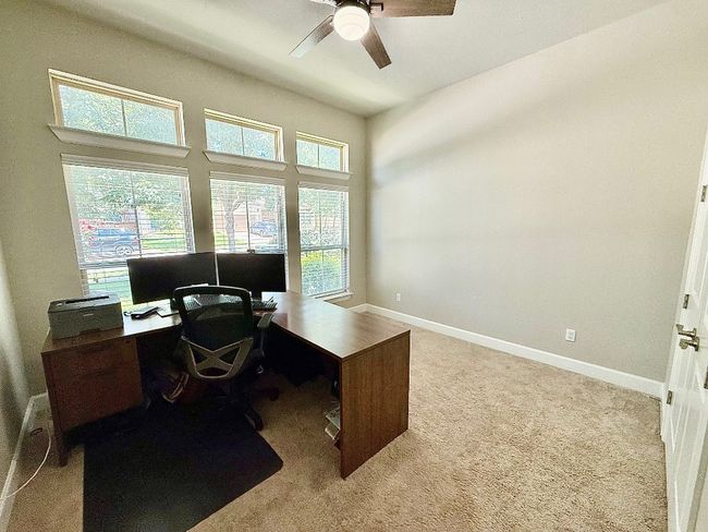 Office with a ceiling fan, carpet floors, and baseboards | Image 15