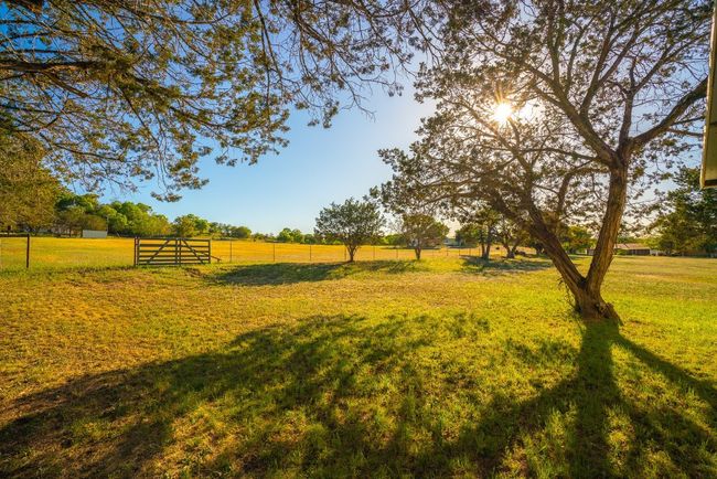 View of yard with a rural view and fence | Image 30