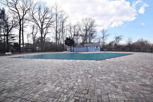 Community pool featuring an outbuilding, an exterior structure, fence, and a patio area | Image 19