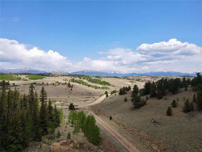 View of mountain backdrop with rural landscape | Image 7