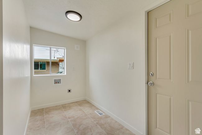 Laundry area featuring laundry area, visible vents, hookup for a washing machine, baseboards, and electric dryer hookup | Image 23