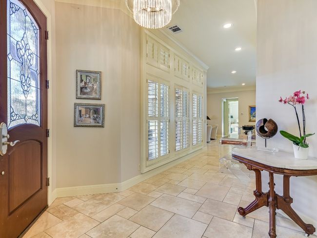 Foyer with healthy amount of natural light, crown molding, recessed lighting, a chandelier, and baseboards | Image 4