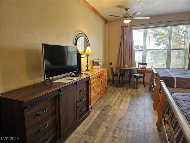 Bedroom featuring light wood finished floors and ornamental molding | Image 10