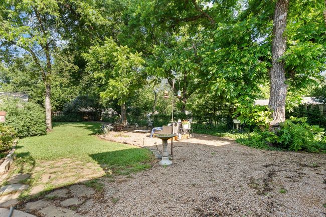 View of green lawn featuring view of wooded area | Image 30