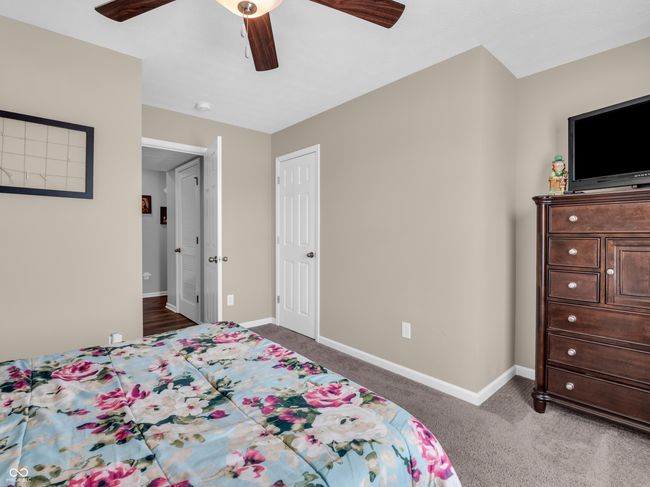 carpeted bedroom featuring baseboards and a ceiling fan | Image 18