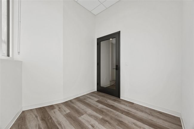 Empty room featuring wood finished floors and baseboards | Image 4