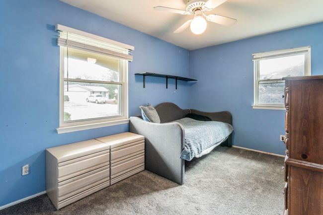 Bedroom with carpet floors, baseboards, and a ceiling fan | Image 20