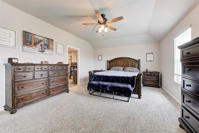 Bedroom with light carpet, vaulted ceiling, ensuite bathroom, and ceiling fan | Image 23