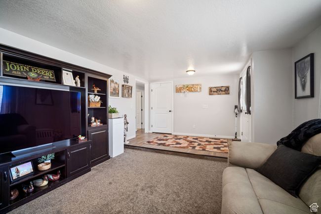 Carpeted living area with baseboards | Image 4