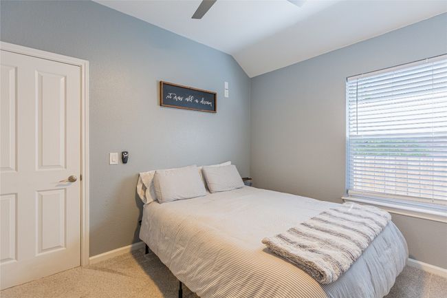 Bedroom featuring carpet floors, lofted ceiling, baseboards, and a ceiling fan | Image 26
