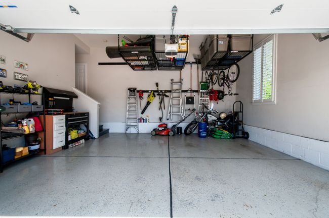 The garage has lofted storage, epoxy floor, a new garage door and opener. | Image 45