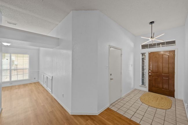 Foyer entrance featuring wood finished floors and a wainscoted wall | Image 8