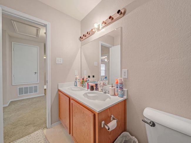 Bathroom featuring toilet and double vanity | Image 26