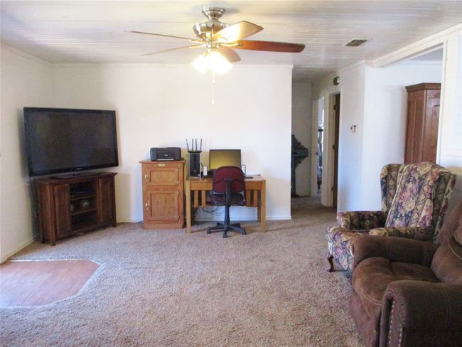 Carpeted office with visible vents and ceiling fan | Image 6