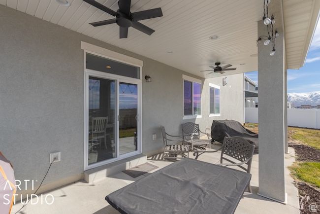 View of patio / terrace with grilling area, ceiling fan, and fence | Image 41
