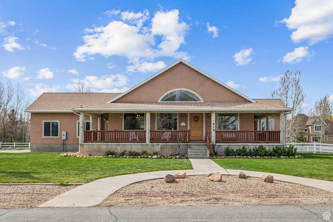 View of front of home with a porch, a front yard, stucco siding, and fence | Image 4