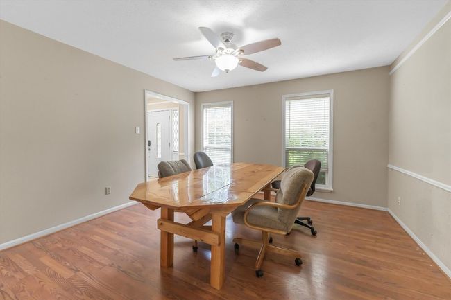 Dining room with a ceiling fan, wood finished floors, and baseboards | Image 15