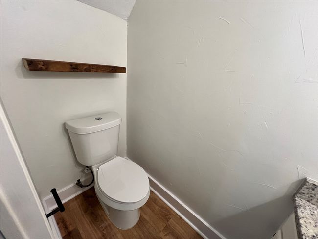Bathroom with toilet, wood finished floors, and baseboards | Image 5