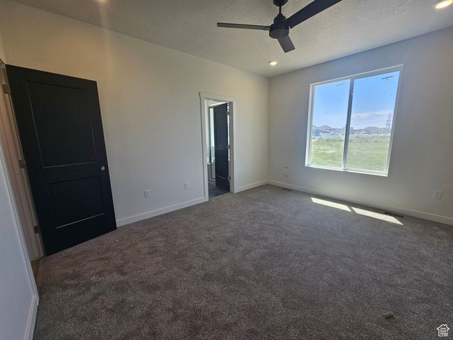 Unfurnished bedroom with carpet floors, baseboards, a textured ceiling, recessed lighting, and ceiling fan | Image 15