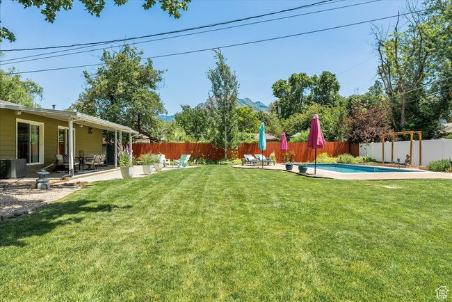 Fenced backyard featuring a patio area | Image 50