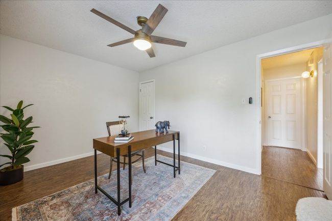 Office space featuring wood finished floors, ceiling fan, and a textured ceiling | Image 22