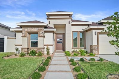 Prairie-style home featuring a garage and a front lawn | Image 2