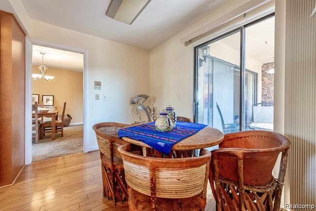 Dining area featuring hardwood / wood-style floors and a chandelier | Image 7