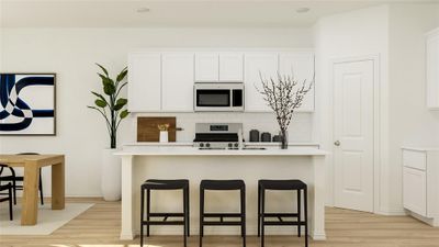 Kitchen with decorative backsplash, an island with sink, stainless steel stove, light wood-type flooring, and white cabinets | Image 3