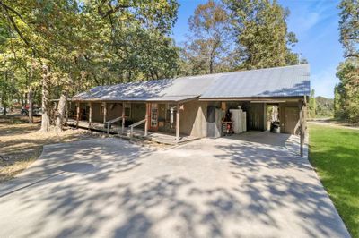 Carport that also doubles as a workshop and storage area | Image 2