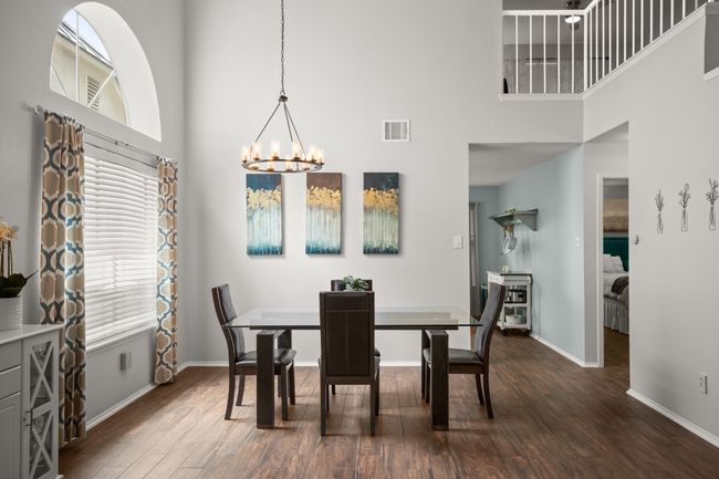 The updated chandelier above the formal dining area adds a touch of modern elegance, perfectly complimenting the natural light pouring in through the large window | Image 9