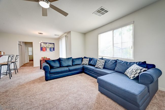 Living area with light carpet and ceiling fan | Image 5
