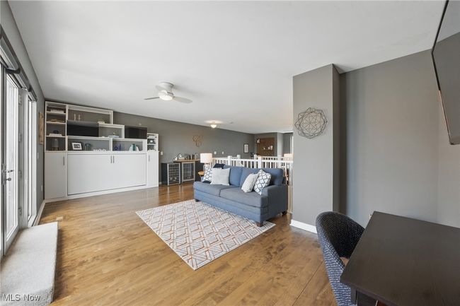 Living area featuring a ceiling fan and wood finished floors | Image 31