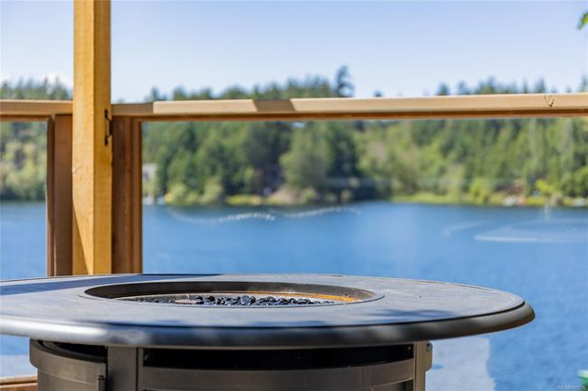 View of lake from deck, featuring outdoor fire table | Image 35