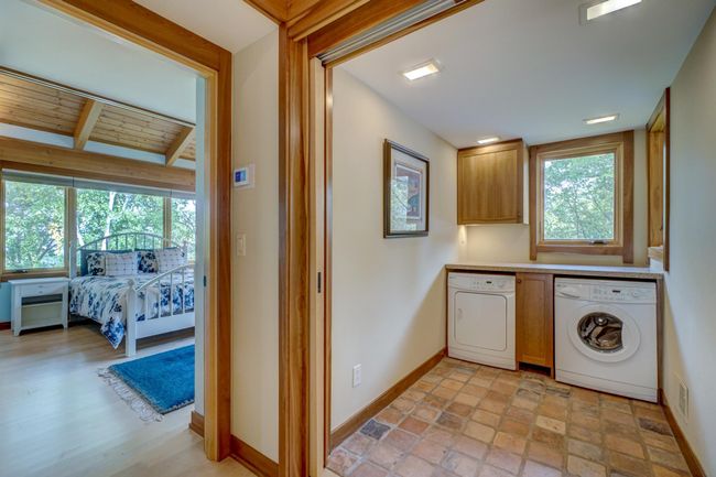 Secondary bedroom and one of two laundry rooms | Image 42
