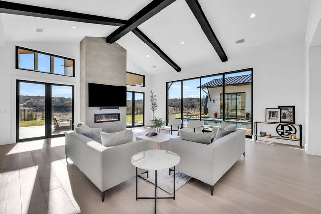 Living room featuring high vaulted ceiling, light wood-style floors, and a healthy amount of natural sunlight | Image 14