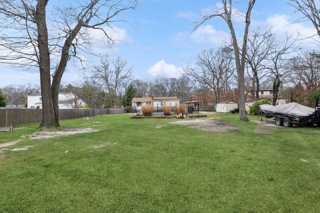 View of yard with an outbuilding and fence | Image 30