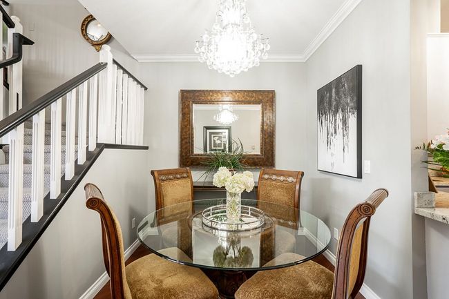 Dining room featuring baseboards, an inviting chandelier, and ornamental molding | Image 8