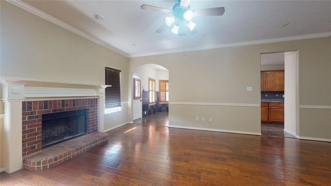 Cozy family room featuring a charming gas log fireplace. | Image 19