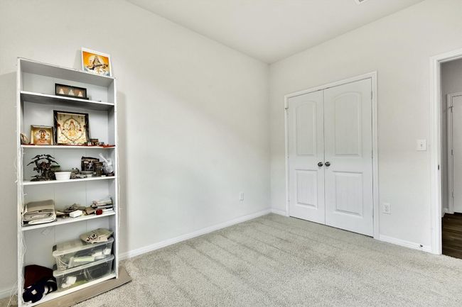 Unfurnished bedroom with carpet floors, baseboards, and a closet | Image 22