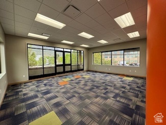 Empty room featuring carpet flooring and a paneled ceiling | Image 12