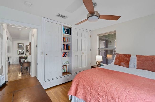 Bedroom featuring wood finished floors, a closet, and a ceiling fan | Image 16