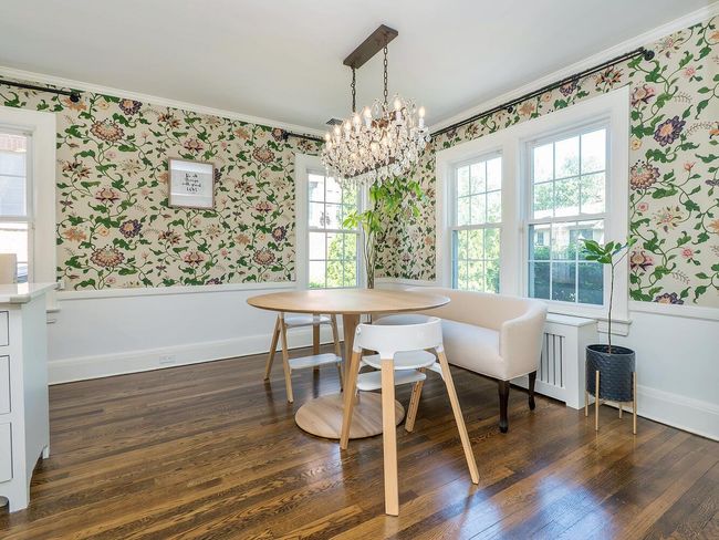 Dining area with wallpapered walls, ornamental molding, plenty of natural light, a chandelier, and dark wood-style flooring | Image 11