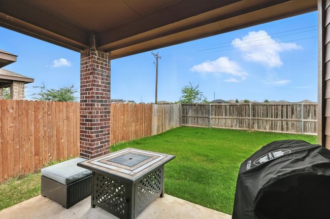 Fenced backyard featuring a fire pit and a patio | Image 18