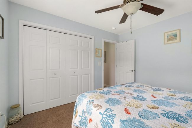 Bedroom featuring carpet flooring, a closet, and a ceiling fan | Image 13