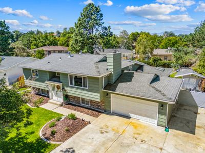 View of front of home featuring a garage and a front yard | Image 2